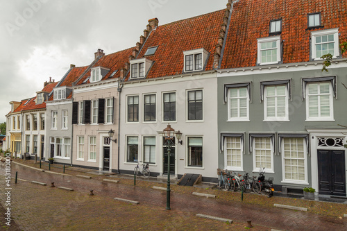 Medieval monumental plastered houses near the harbor in Wijk bij Duurstede, Netherlands.