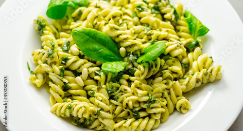 Pesto and pine nut pasta salad, fusilli pasta with regato cheese and baby spinach coated in basil pesto