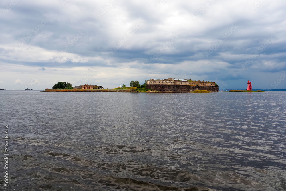 Fort Kronshlot in the Gulf of Finland. Sea fortress, fort in Kronstadt, Russia. Dramatic clouds and sky, huge storm clouds over sea