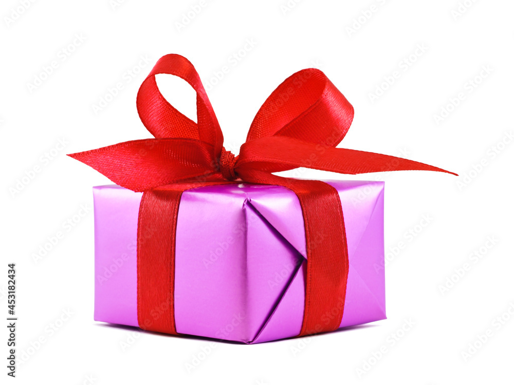 Obraz premium Purple gift wrapped present with red satin ribbon bow isolated on white