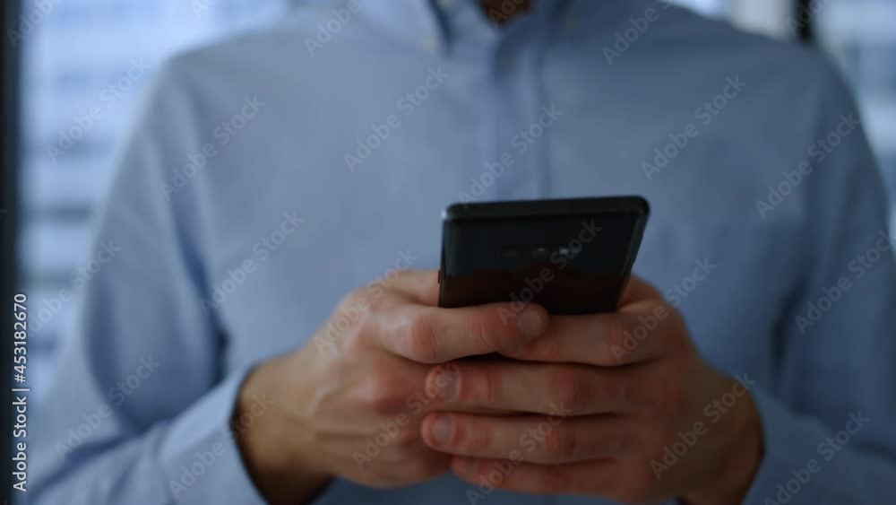 Smartphone in business man hands. Closeup businessman hands using mobile phone Smartphone in business man hands. Closeup businessman hands using mobile phone