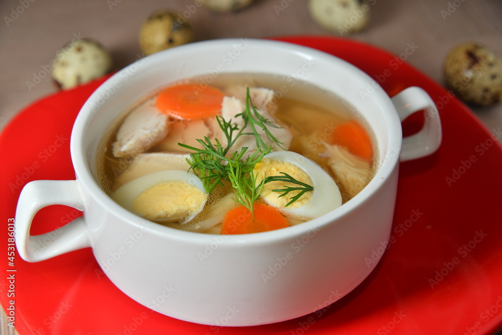 Chicken soup with egg and dill in the white bowl. Chicken soup with egg and dill in the white bowl.