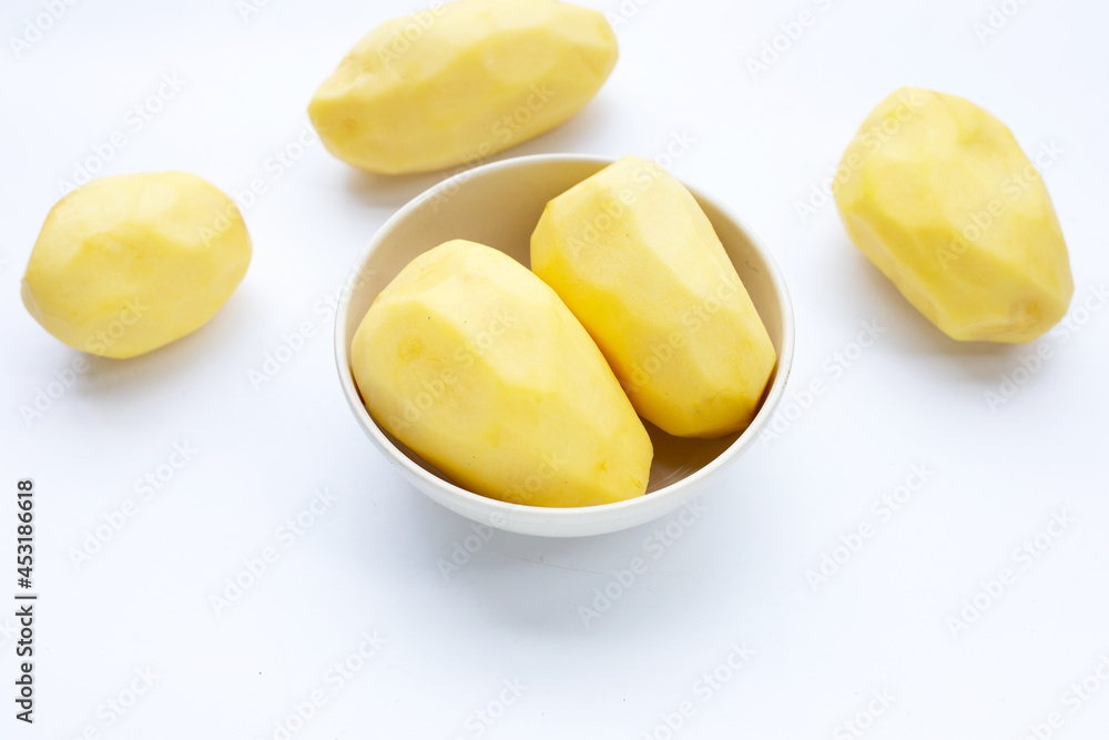 Raw peeled potatoes on white background