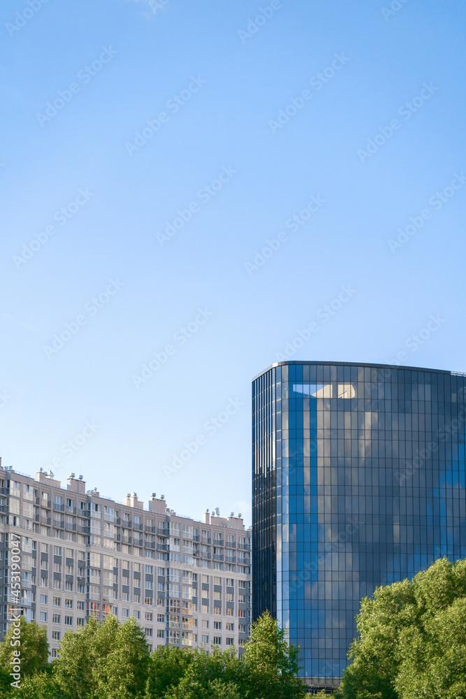 high-rise building with many windows, blue sky background