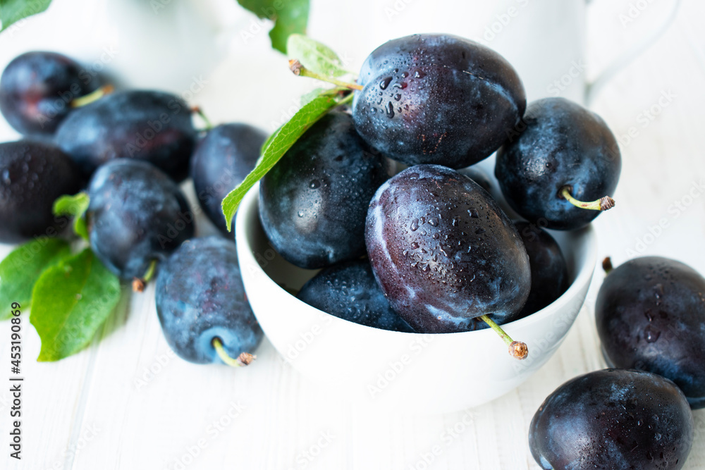 ripe sweet blue plums in a white plate ripe sweet blue plums in a white plate