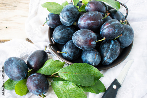 ripe sweet blue plums on a table