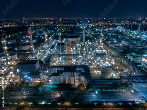 Aerial view Oil refinery. Industrial view at oil refinery plant form industry zone with sunrise and cloudy sky. © MAGNIFIER