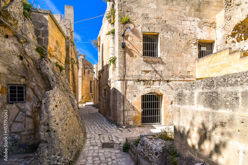 Fototapeta Naklejka Na Ścianę i Meble -  A typical stone back street and narrow alley in the ancient sassi of Matera Italy.