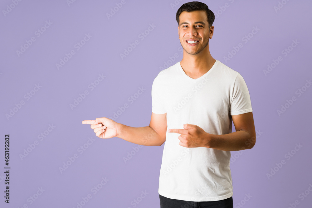 Hispanic young man showing copyspace Hispanic young man showing copyspace