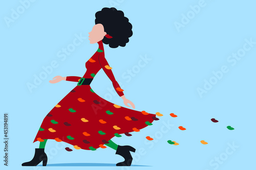 Vector graphics-a pretty supermodel goes in a fashionable dress with crumbling multicolored foliage isolated. Concept-autumn fashion collection