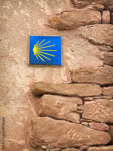 Camino de Santiago Way Marker with the Scallop Shell on a House Wall in Cirauqui on the Way of St James Pilgrim Trail Camino de Santiago photo
