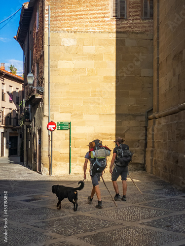 Pilgrims and Dog Walking the Streets of Santo Domingo Historic Old Town along the Way of St James Pilgrim Trail Camino de Santiago