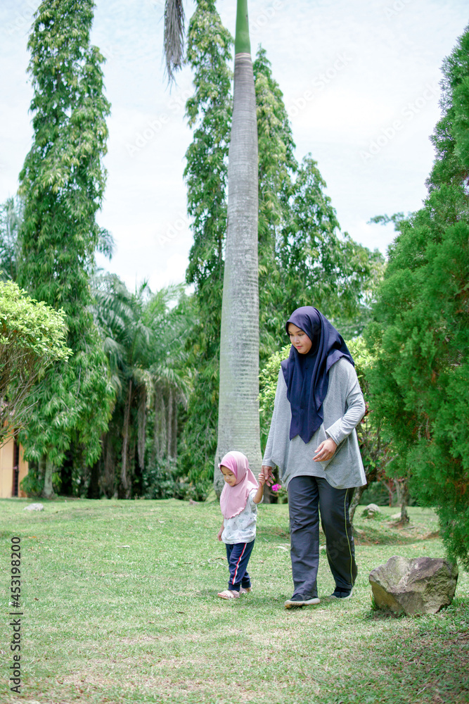 Beautiful asian mom and baby playing happiness in the park , outdoor ,mother day concept Beautiful asian mom and baby playing happiness in the park , outdoor ,mother day concept