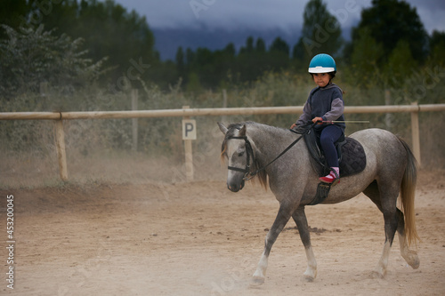 5-year-old girl riding a horse. infalltil sport concept