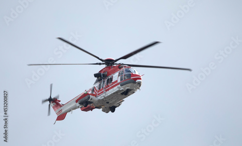 Ambulance, military or civilian helicopter on sky background.