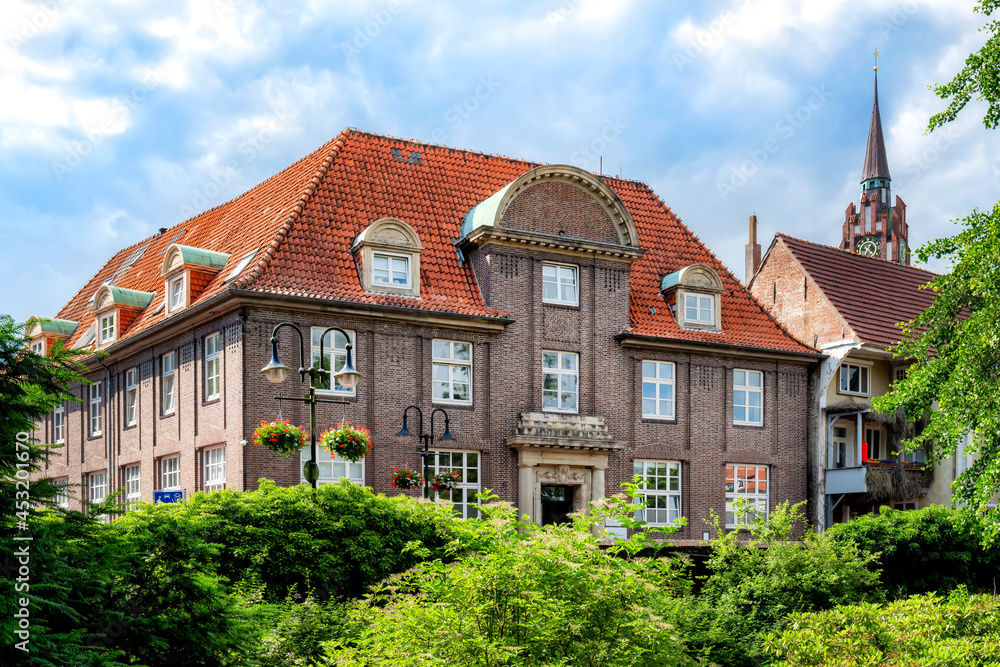 Landessparkasse Oldenburg in Jever with city church in background, Lower Saxony, Germany Landessparkasse Oldenburg in Jever with city church in background, Lower Saxony, Germany
