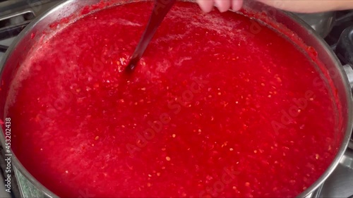 Slow motion boiling tomatoes sauce. Autumn conserve. HD footage. Close up.