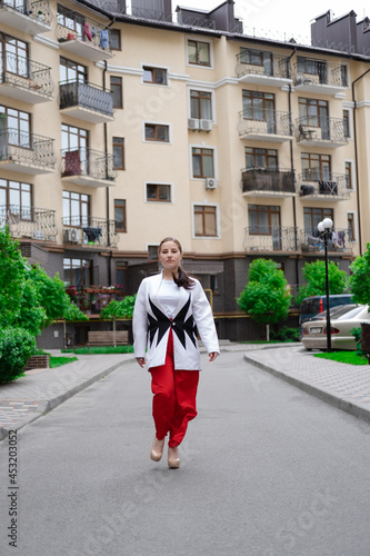 Wallpaper Mural business woman in red pants, white blouse and jacket walking by the street Torontodigital.ca