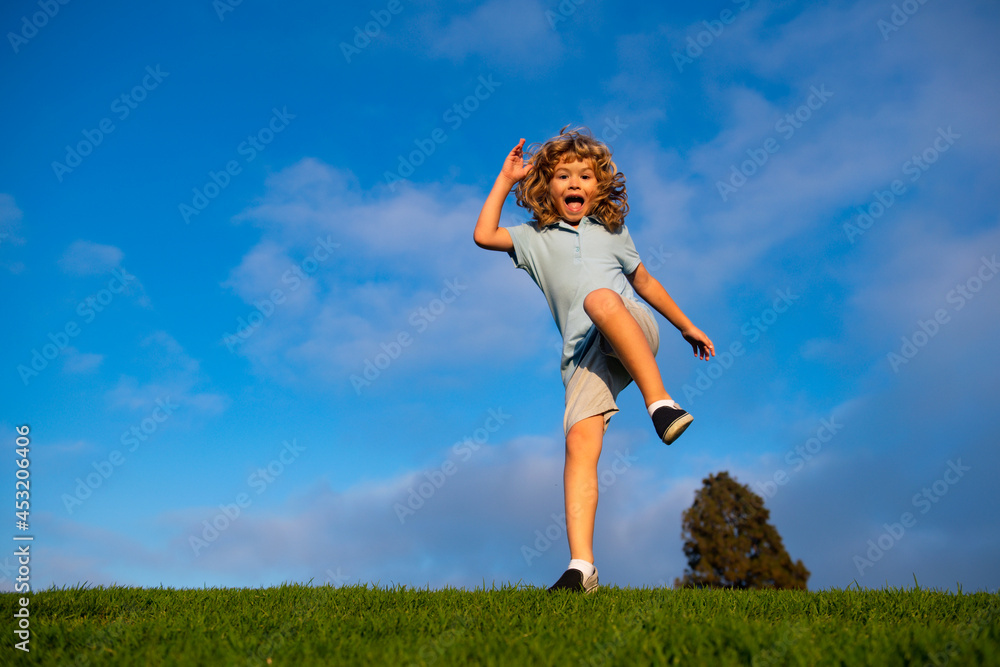 Caucasian boy in a park running and smiling. Happy kid laughing. Emotion face joy child. Joyful, funny spring, summer day, outdoors. Sky background, banner with copy space. Caucasian boy in a park running and smiling. Happy kid laughing. Emotion face joy child. Joyful, funny spring, summer day, outdoors. Sky background, banner with copy space.