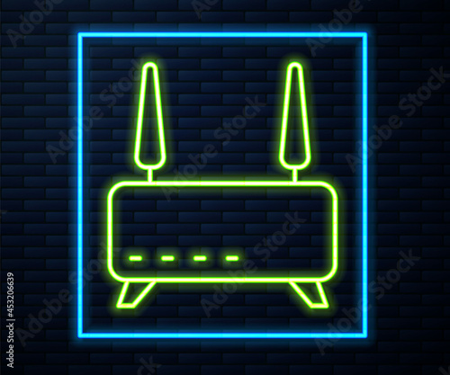 Glowing neon line Router and wi-fi signal icon isolated on brick wall background. Wireless ethernet modem router. Computer technology internet. Vector