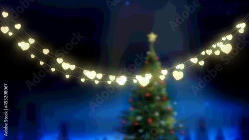 Animation of glowing fairy lights over christams tree and winter landscape photo