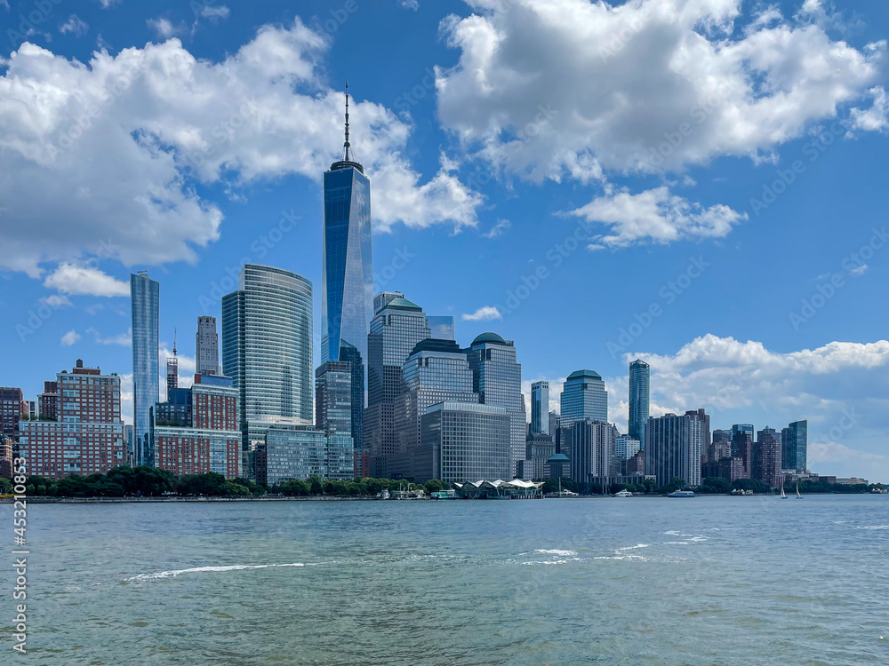 Obraz premium New York, NY - USA - July 30, 2021: Horizontal view of the skyline of lower Manhattan's Financial district, with the World Trade Canter, World Financial Center and Battery Park City.
