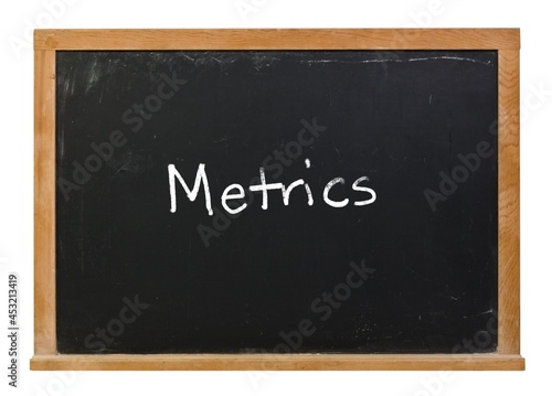 Metrics written in white chalk on a black chalkboard isolated on white