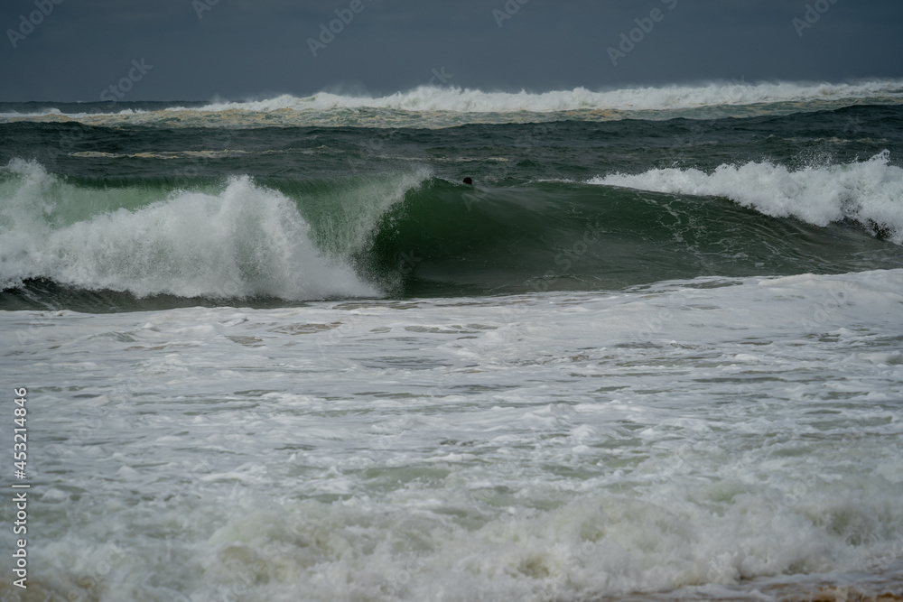 big barreling waves breaking on the beach