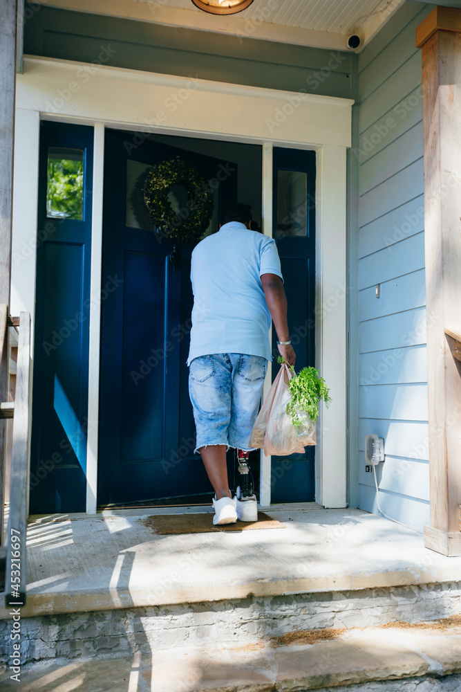 African American man brings home groceries African American man brings home groceries