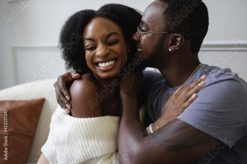 Smiling African American couple embracing