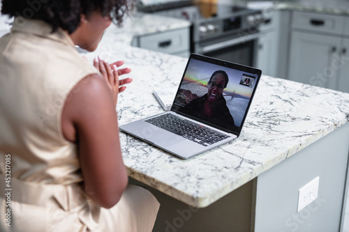 Black woman having video chat with client consultant  photo