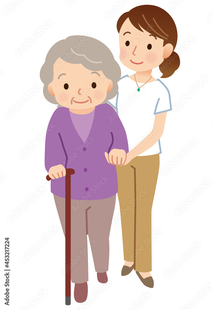 杖をついて歩く高齢者　寄り添う介護士
