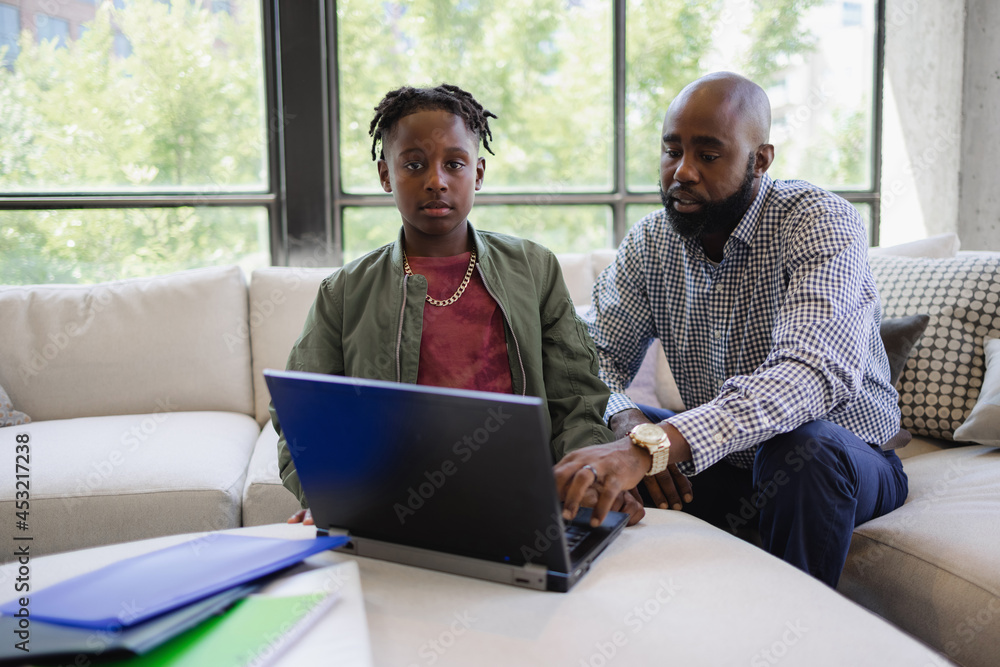 Father and son using laptop together Father and son using laptop together