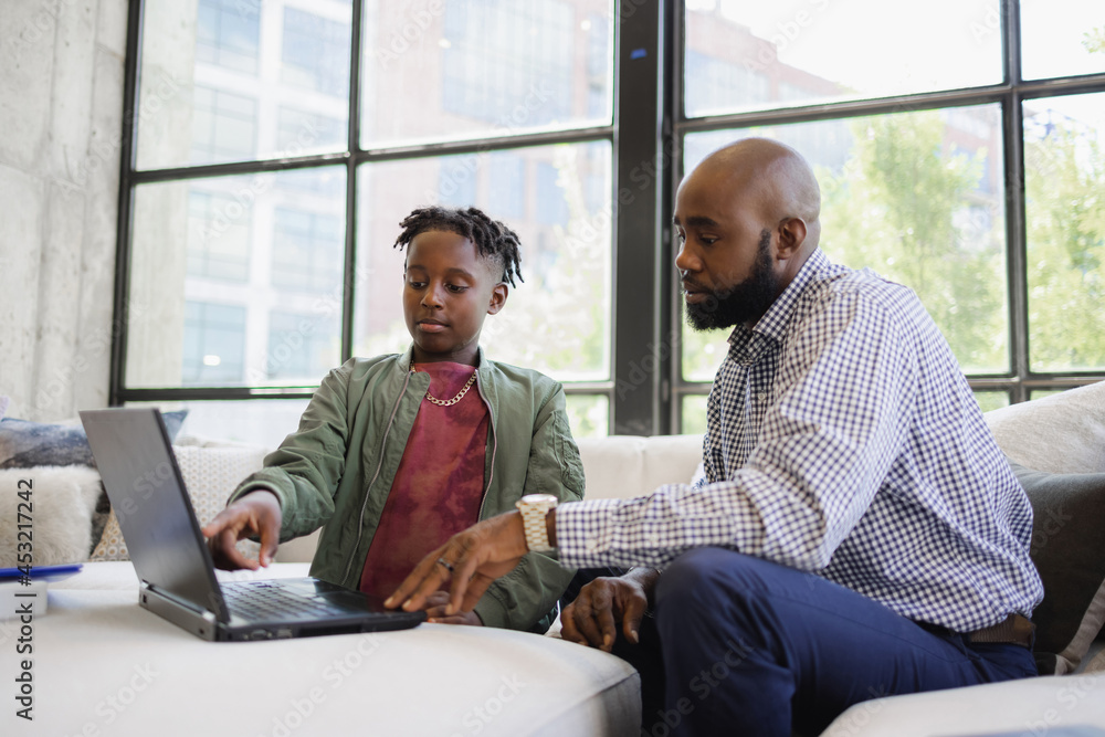 Black dad working from home with son Black dad working from home with son