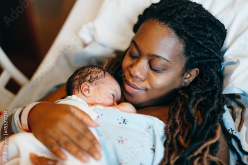 Black mother and son bonding with skin to skin time photo