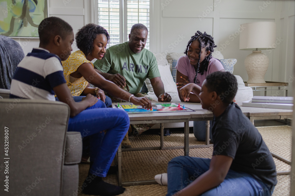 Black army family playing board games at home Black army family playing board games at home
