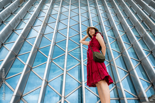 Asian woman in red dress at modern building, female girl with urban city lifestyle