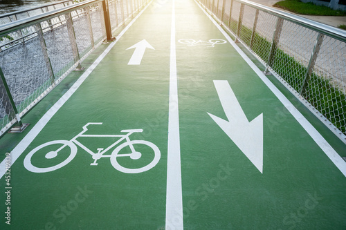 View of bicycles symbol and arrow marking on green bike lane. A Bike Lane is defined as a portion of the roadway that has been designated by striping, signage or exclusive use of bicyclists.