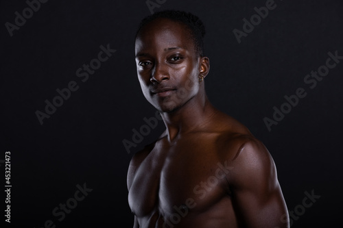 Fit African American man with muscles posing in studio photo