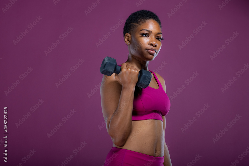Black woman doing workout with dumbbells Black woman doing workout with dumbbells