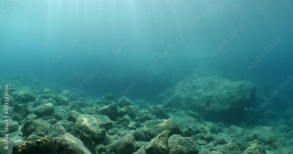 sun ray and sun beam scenery underwater waves on surface of water slow ocean scenery on the stones shallow water sun ray and sun beam scenery underwater waves on surface of water slow ocean scenery on the stones shallow water
