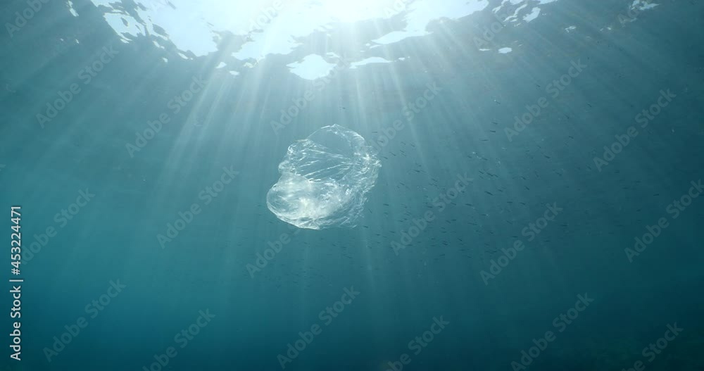 plastic bag underwater bad for fish with sun rays water waves hit to