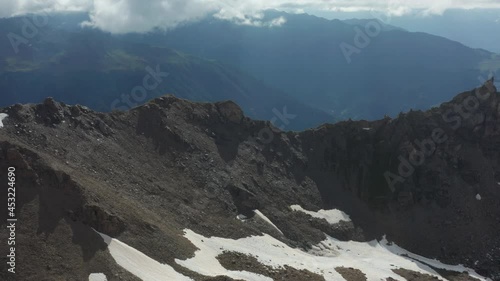 Drone flying away from rocky mountain slope photo