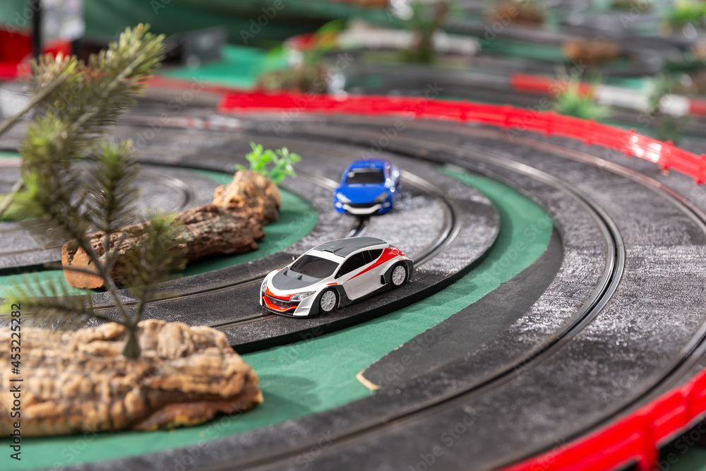View of electric slot cars on the toy race track ready to play