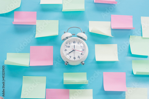 Sticky notes and clocks on office walls, resolutions, memos, goals, posts, memos or action plan ideas, deadlines concept.