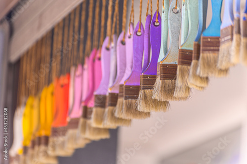 multi-colored brushes hang. Selective focus. background with paint brushes. © Marina Gordejeva
