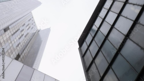 City skyscrapers low angle with sky. The corporate buildings create an imposing claustrophobic skyscape