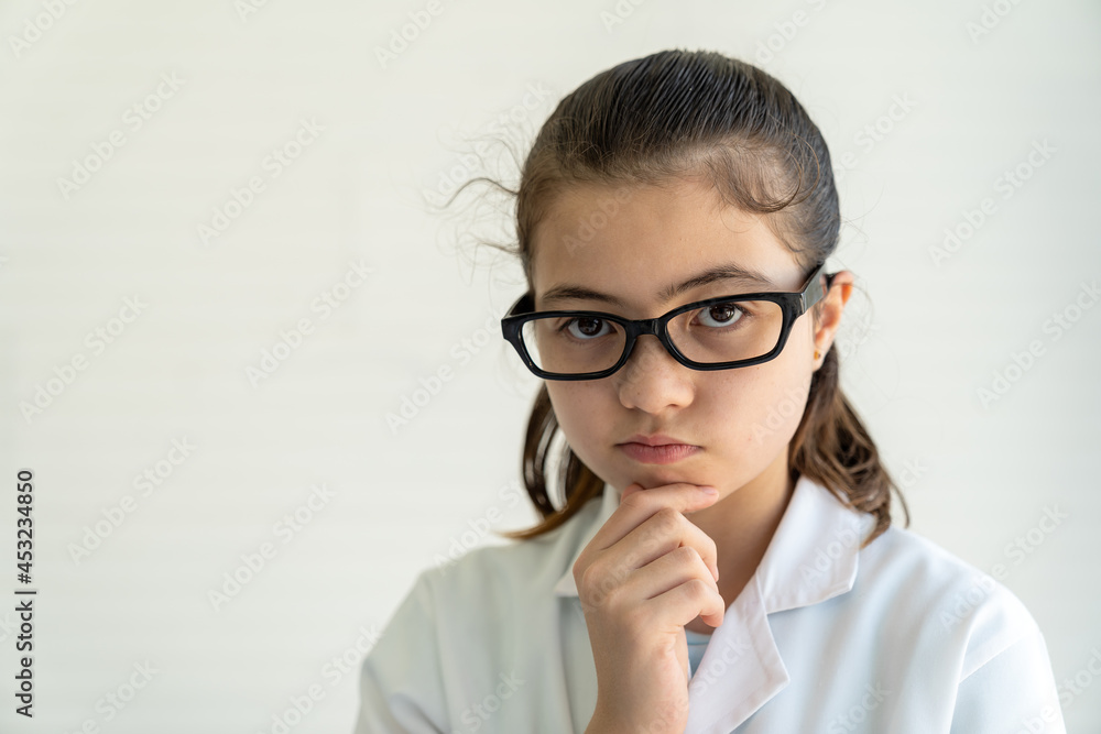 Child girl scientists learning science wearing white uniform and glasses in classroom or laboratory. Early development of children. Medical, Lab, Scientific experiment, Researcher, Research concept Child girl scientists learning science wearing white uniform and glasses in classroom or laboratory. Early development of children. Medical, Lab, Scientific experiment, Researcher, Research concept