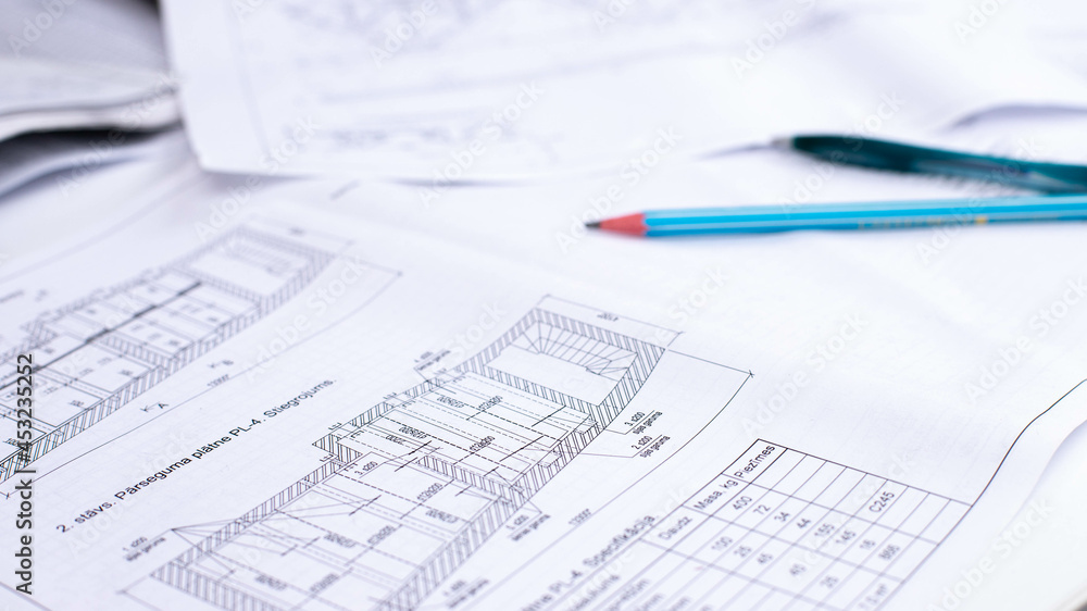 drawings of a construction engineer on a sheet of paper drawings of a construction engineer on a sheet of paper