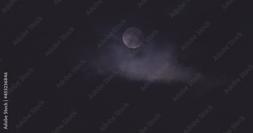 thick dark clouds in front of the full moon thick dark clouds in front of the full moon